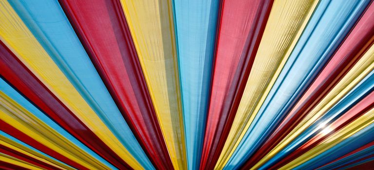 Vibrant canopy with red, blue, and yellow stripes forming a mesmerizing pattern